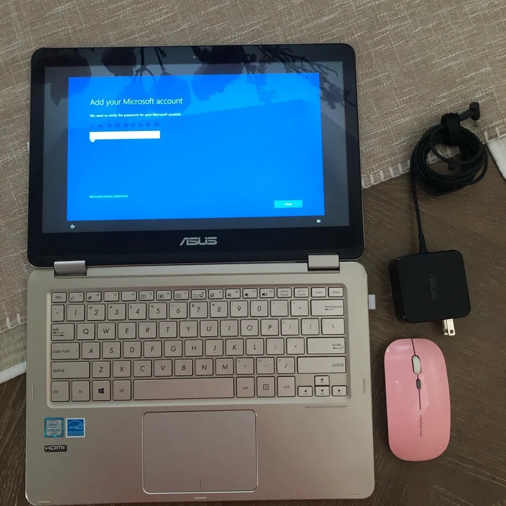 ASUS Metallic Silver Convertible Laptop with a wireless mouse and a charger.